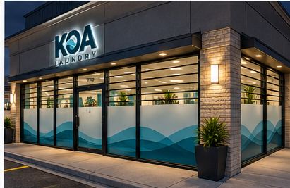 KOA Laundry storefront lit up at night
